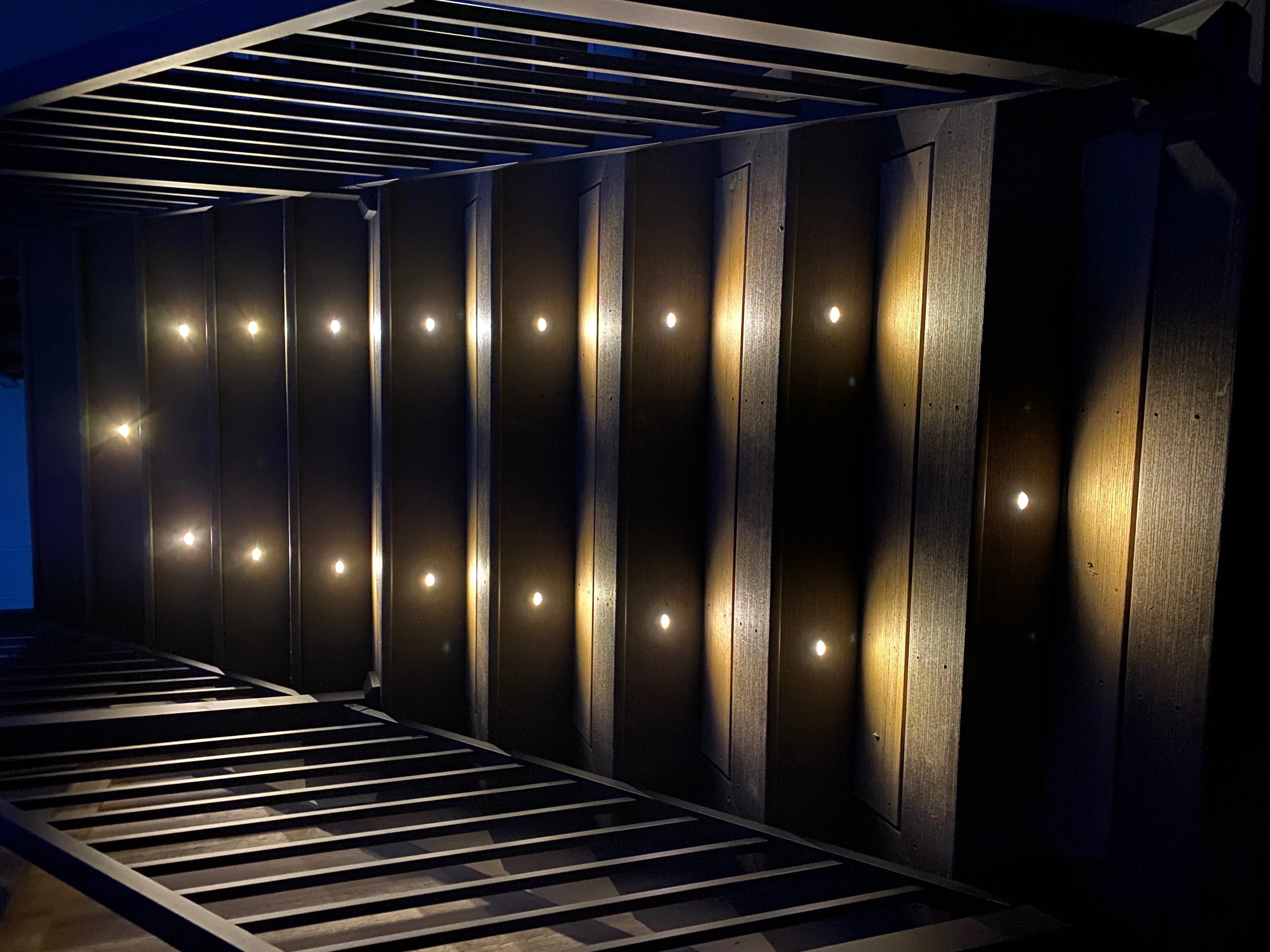 Aluminum pergola with LED lighting on vertical posts and overhead linear lights